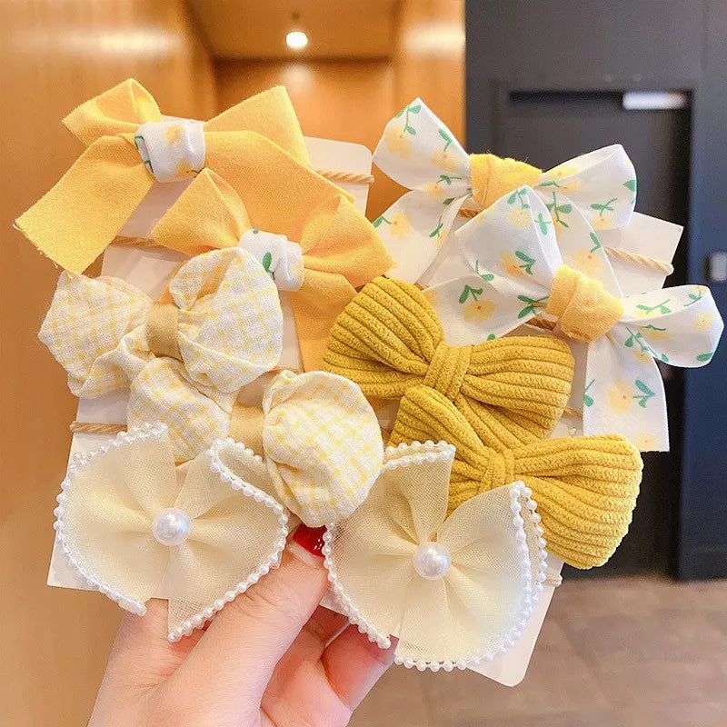 Party-ready flower bow hairbands, 10-pack for girls. Cute elastic hair accessories.