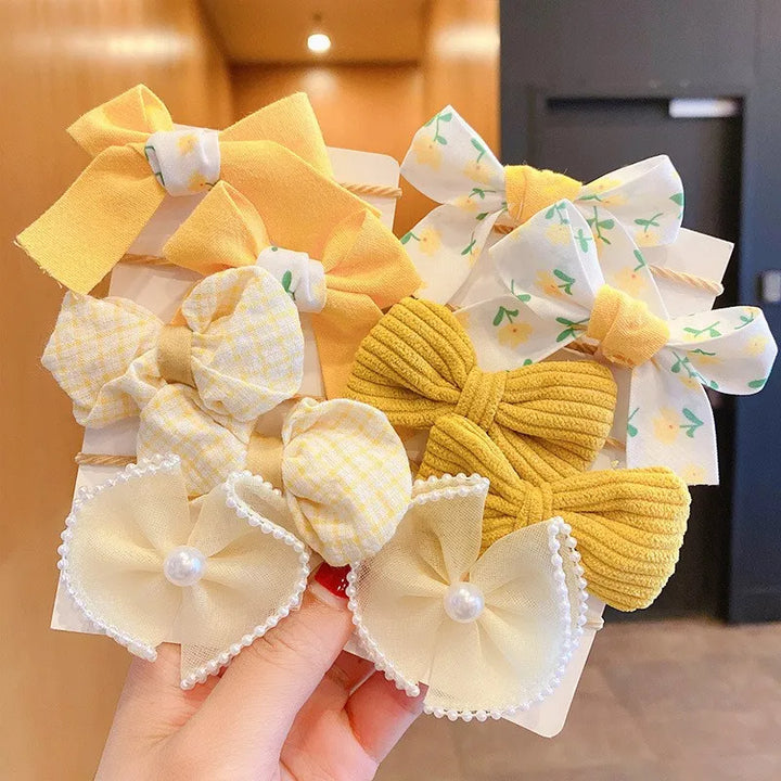 Party-ready flower bow hairbands, 10-pack for girls. Cute elastic hair accessories.