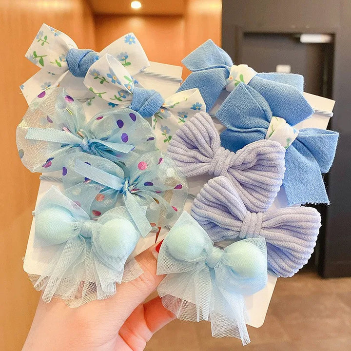Vibrant 10-pack flower bow hairbands for girls. Soft nylon elastic headbands.