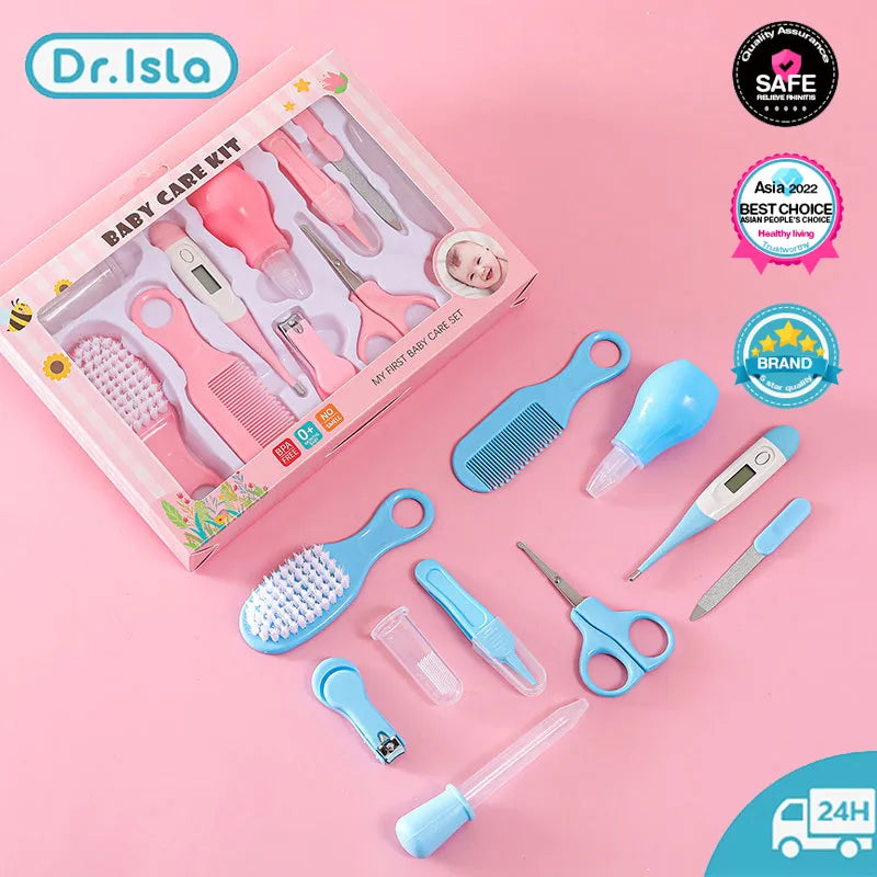 Close-up of a baby health kit, showing thermometer, nail clippers, and soft brush on white