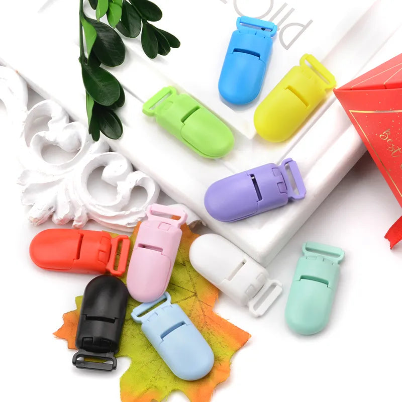 Display of 10 colorful silicone bead pacifier clips on a neutral background