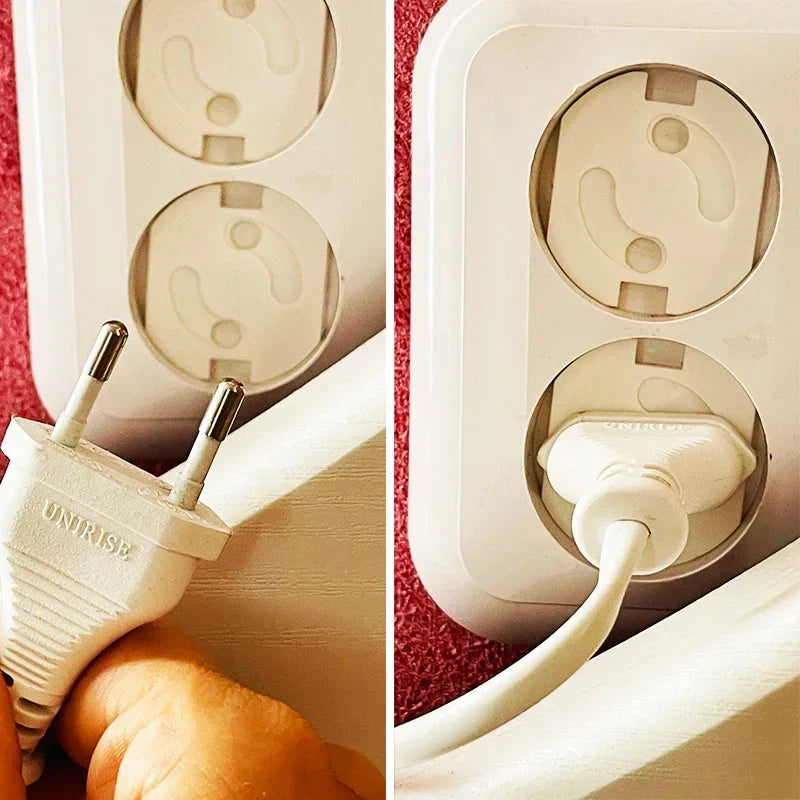 Child's hand attempting to touch an electrical outlet with a white socket cover installed