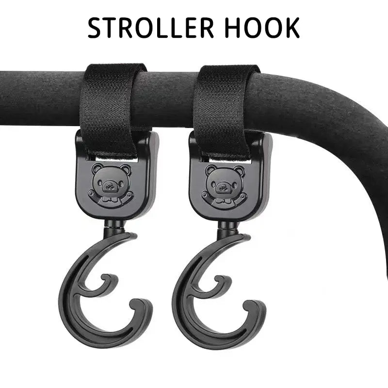 Pair of black plastic pram clips featuring a cartoon car, essential for hanging baby accessories