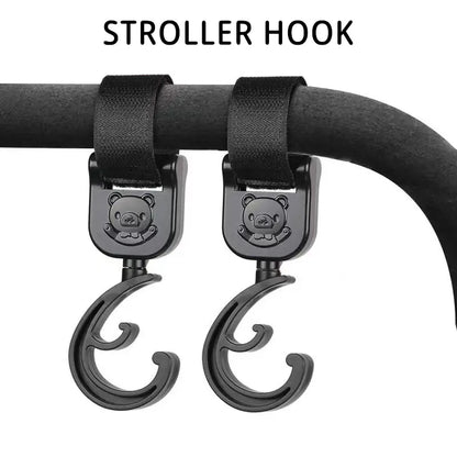 Pair of black plastic pram clips featuring a cartoon car, essential for hanging baby accessories
