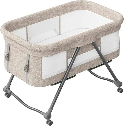 Multi-functional baby travel crib with silent wheels and rocker bassinet, an essential piece of baby gear.