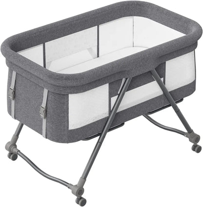 Co-sleeper rocker bassinet & travel crib, designed for baby's comfort with silent wheels.