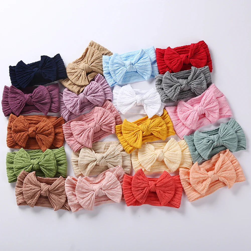 Assortment of infant cable bow headbands in various colors, baby shower gift idea