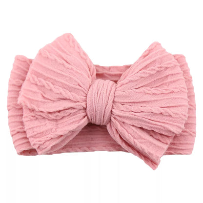 Displayed collection of 20 baby cable bow headbands, perfect for everyday wear