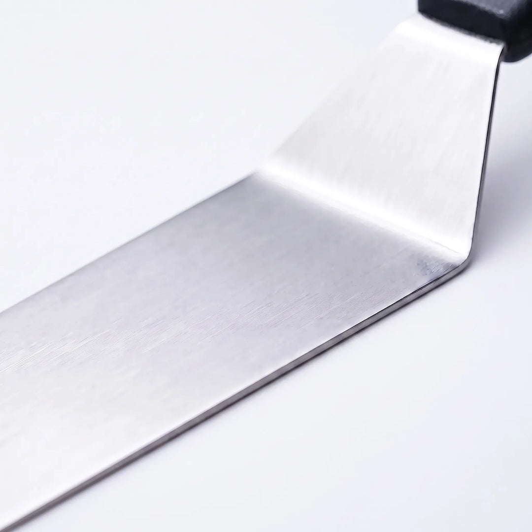 Close-up of durable stainless steel BBQ tools from a 29-piece professional utensil set for grilling.
