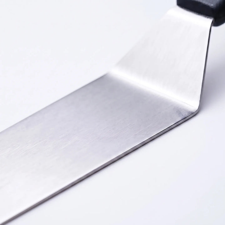 Close-up of durable stainless steel BBQ tools from a 29-piece professional utensil set for grilling.