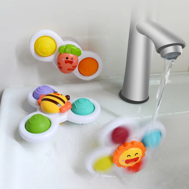 Yellow spinning top, a developmental baby toy with strong suction cups for easy attachment