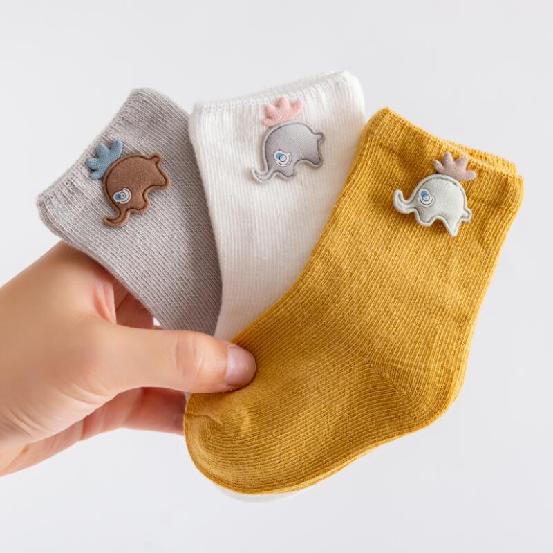 Comfort-focused cotton newborn socks, three pairs, featuring a gentle elastic opening.