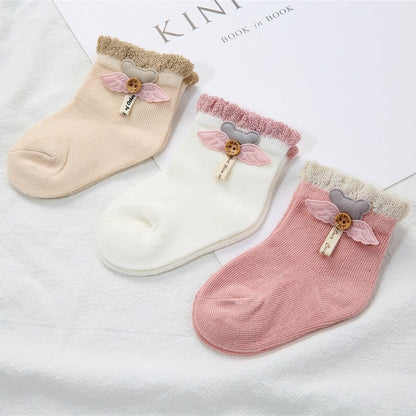 Close-up of a white baby's cotton newborn sock, showing the soft texture and stitching.