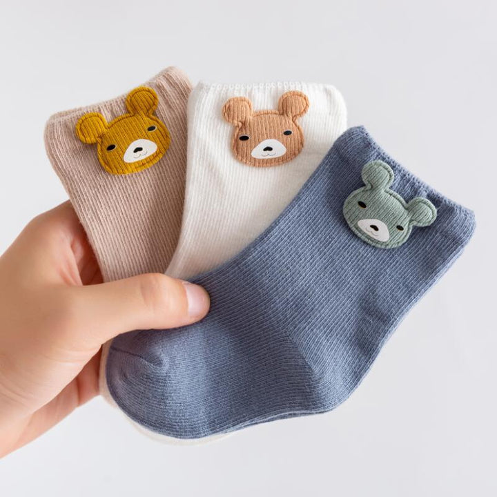 Newborn socks set: three pairs of stretchable, soft cotton baby socks in pastel colors.