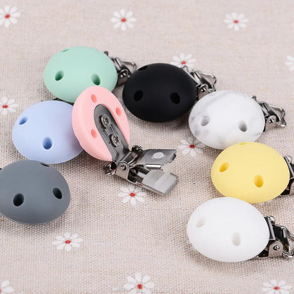 Durable round silicone pacifier clips, 5-pack, BPA-free, attach securely to baby clothes.