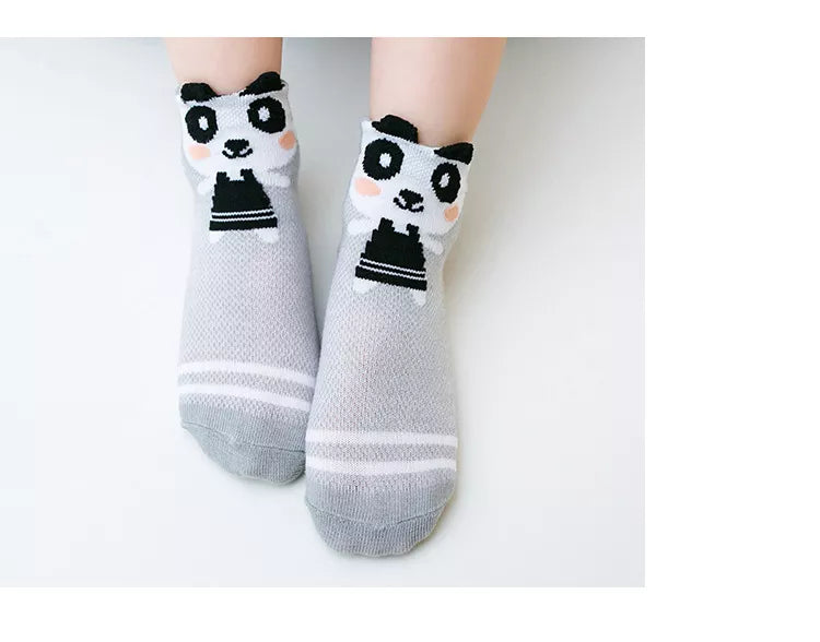 Five pairs of white cotton mesh baby socks, displayed neatly against a plain background