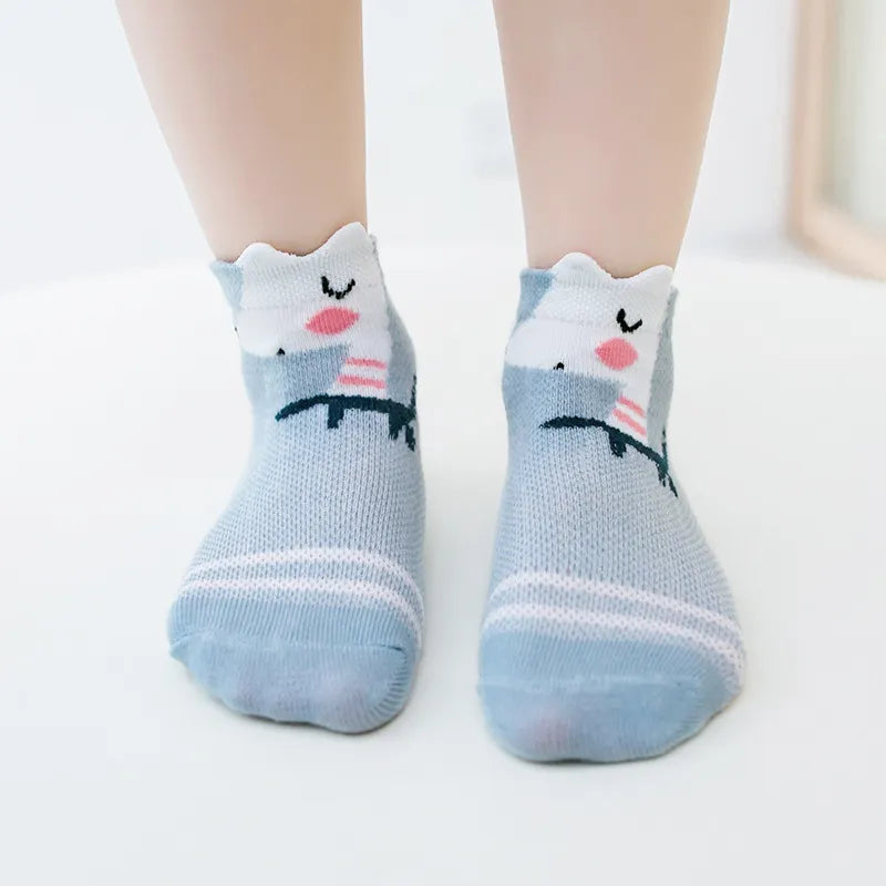 Close-up of a single white cotton mesh baby sock, soft and breathable for newborns