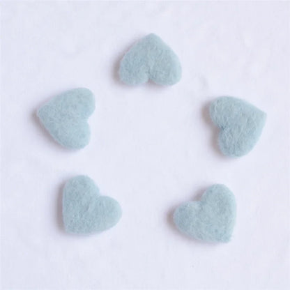 Infant photoshoot accessories: a selection of small wool love hearts, handmade for newborns
