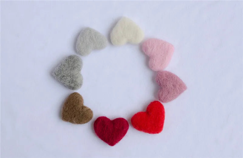 Assorted wool love heart props in red, pink, and white, designed for newborn photography sessions