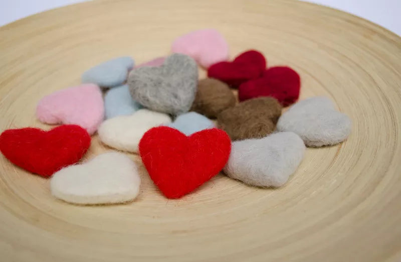 Collection of handcrafted wool hearts, essential newborn photography props for a studio setting