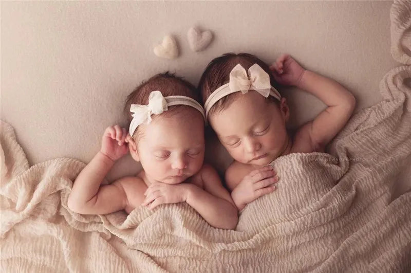 Newborn photography props: a collection of red and pink wool hearts for infant pictures