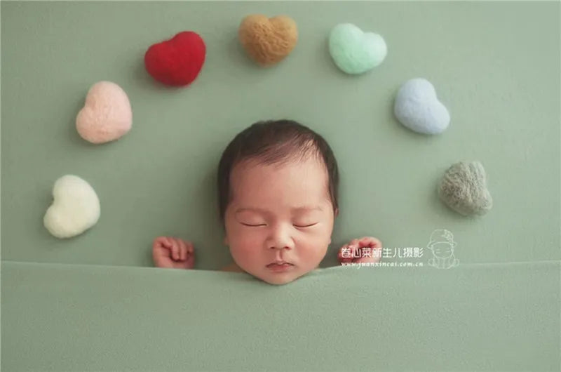 Adorable wool hearts, part of a 5-piece newborn photography prop set, in a soft pastel palette