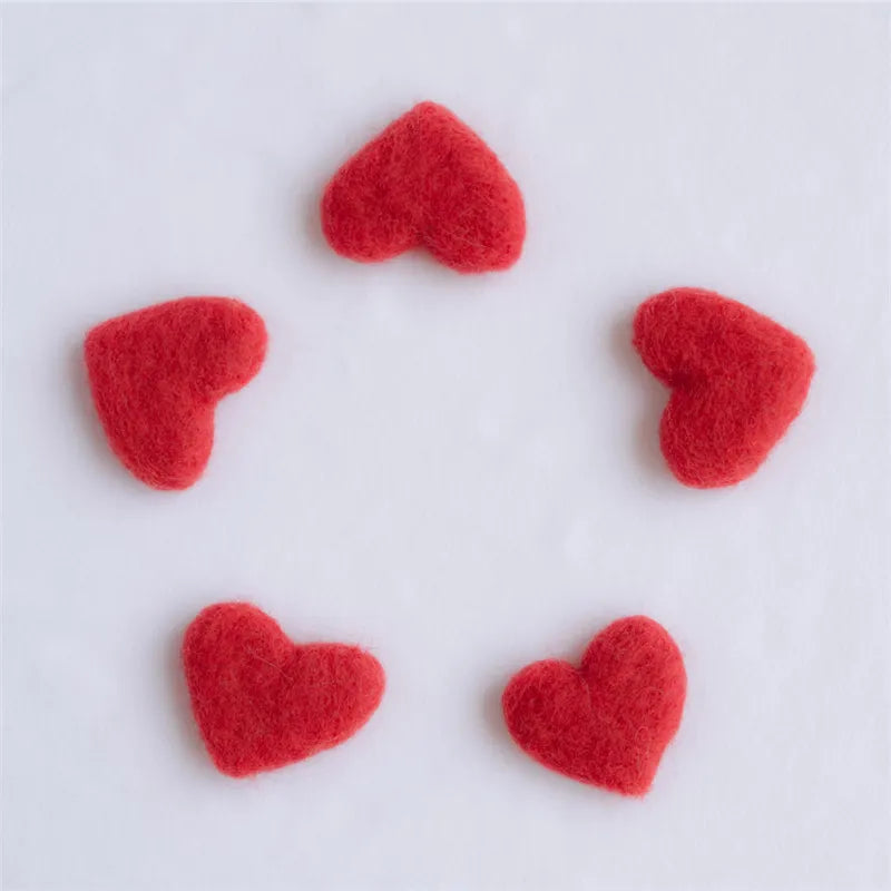 Carefully arranged wool love hearts for newborn photography, showcasing the prop set's variety