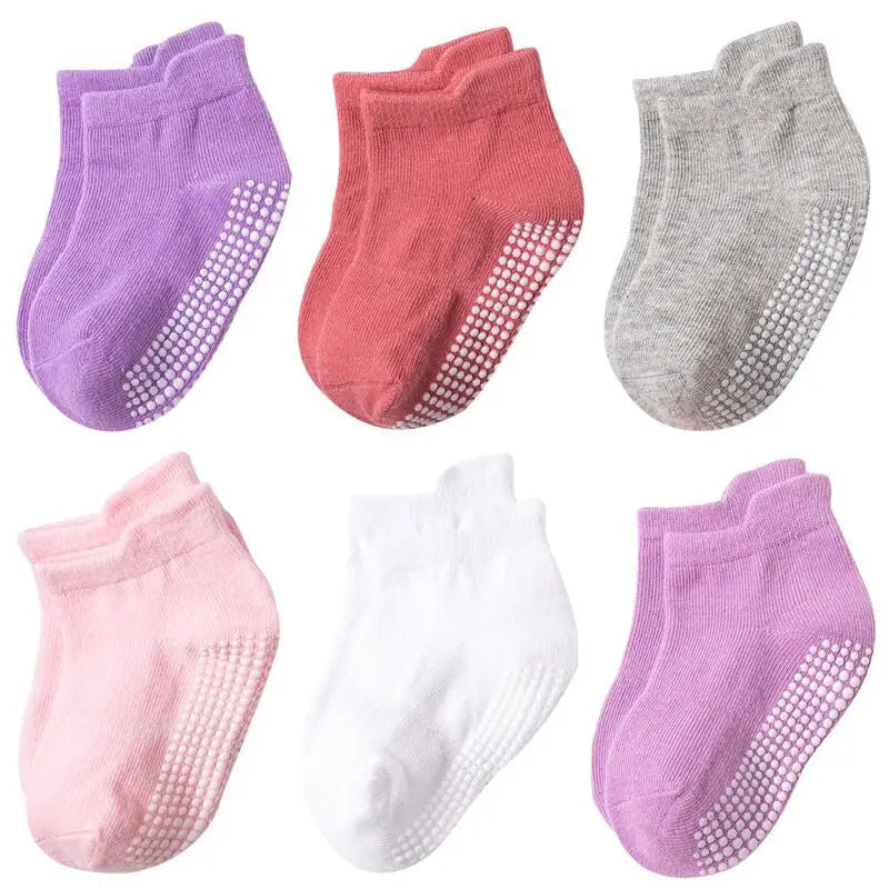 Child's feet in anti-slip cotton socks standing on a mat, ready for spring & autumn adventures