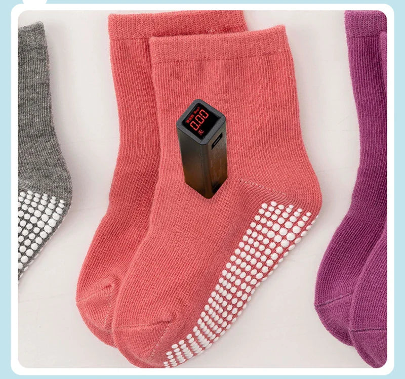 Child crawling on the floor with anti-slip cotton socks, safe and comfortable for baby play