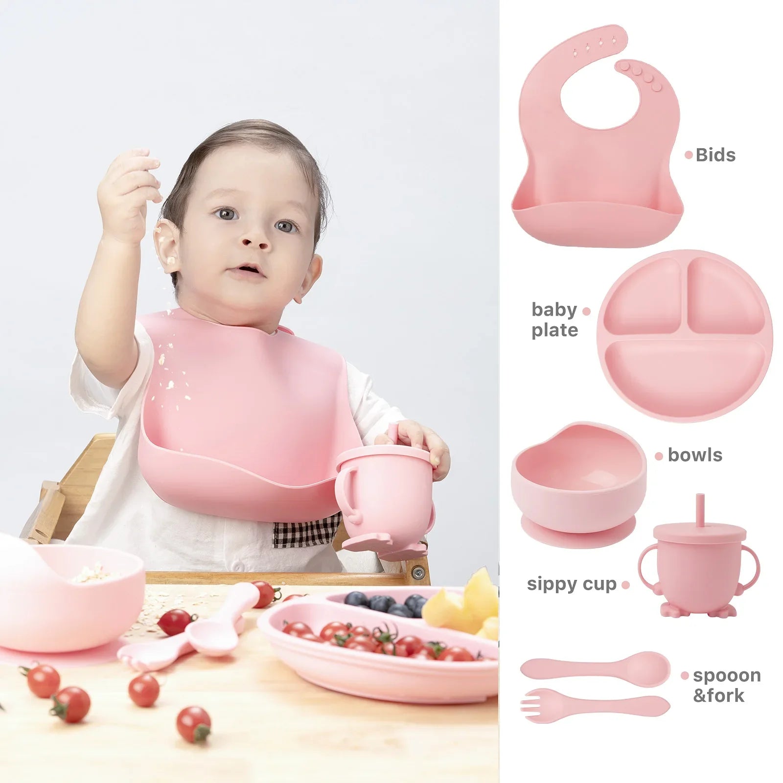 Durable children's silicone bib, divided plate, deep bowl, training cup, and two spoons, all in sage green.