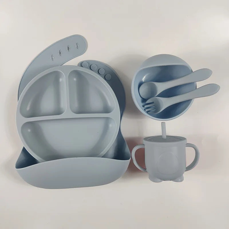 Soft silicone feeding set for babies and toddlers, with a strong suction plate and bowl to prevent spills.
