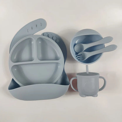 Soft silicone feeding set for babies and toddlers, with a strong suction plate and bowl to prevent spills.