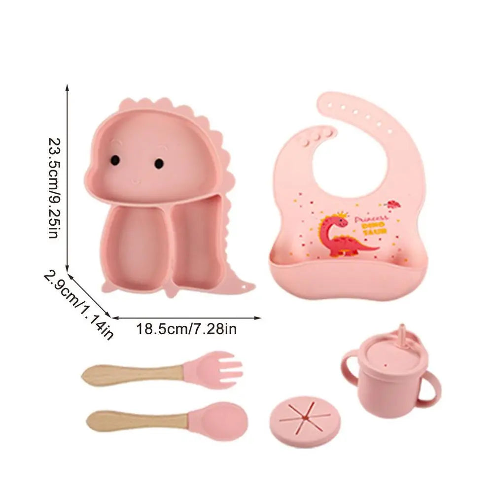 Green dinosaur silicone suction cup and bib from a 7-piece toddler feeding essentials set, safe & durable