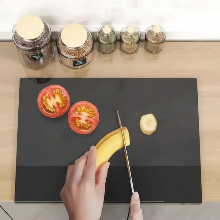 Non-slip acrylic cutting board with protective lip for secure food prep, protects kitchen countertops.