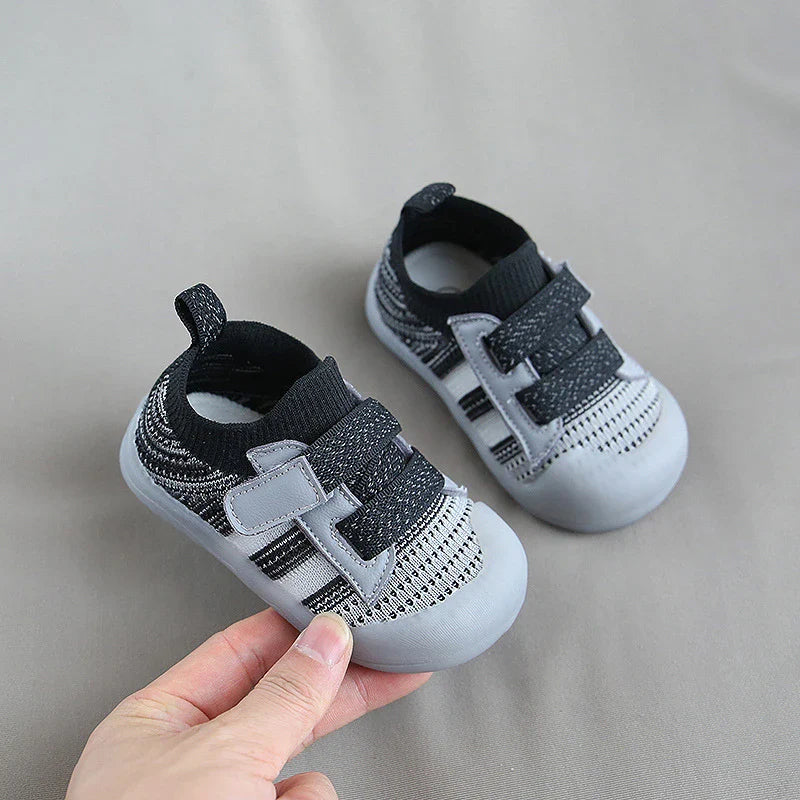 Front view of blue children's sports shoes, emphasizing breathable mesh design
