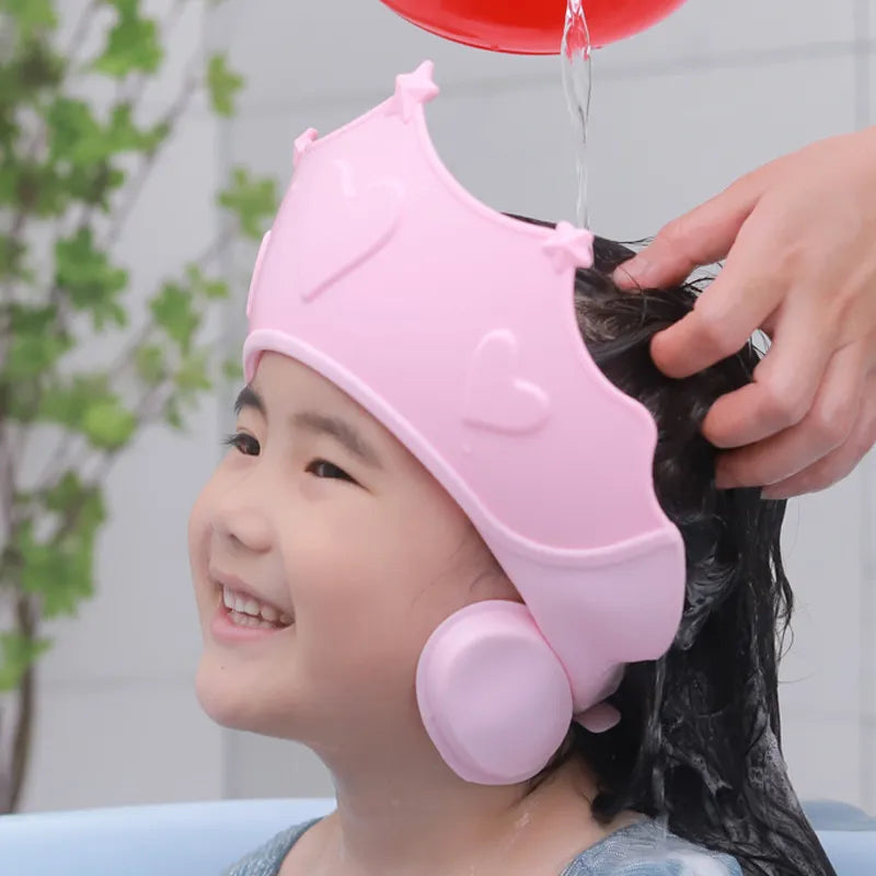 Adjustable baby shower cap with ear protection, soft, yellow, for comfortable infant bathing.