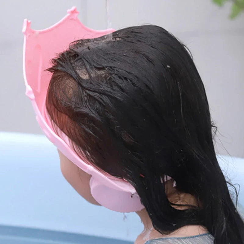 Pink baby shower cap with ear protection for toddlers, waterproof and resizable for hair wash.