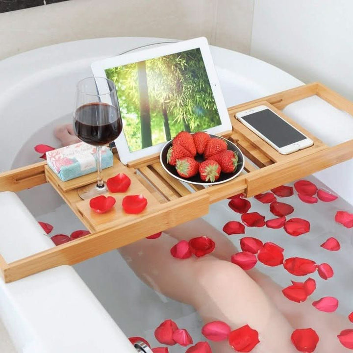 Relax with an adjustable bamboo bath caddy holding your book, wine, and candles for a perfect spa retreat.