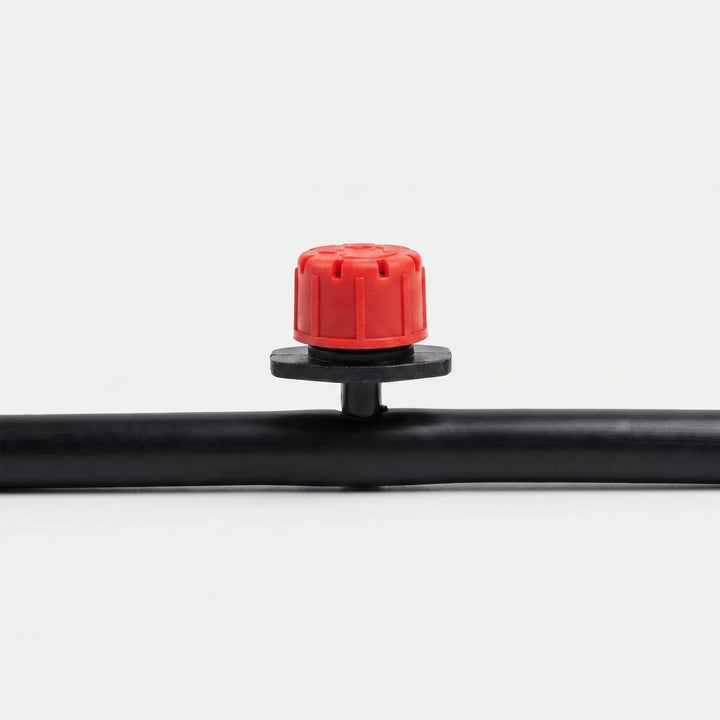 Close-up of an adjustable garden dripper, essential for targeted micro-irrigation and efficient plant watering.