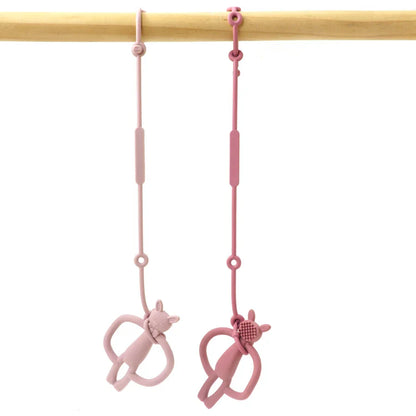 Adjustable silicone pacifier clip in a neutral color, securely holding a baby pacifier, for newborns & infants