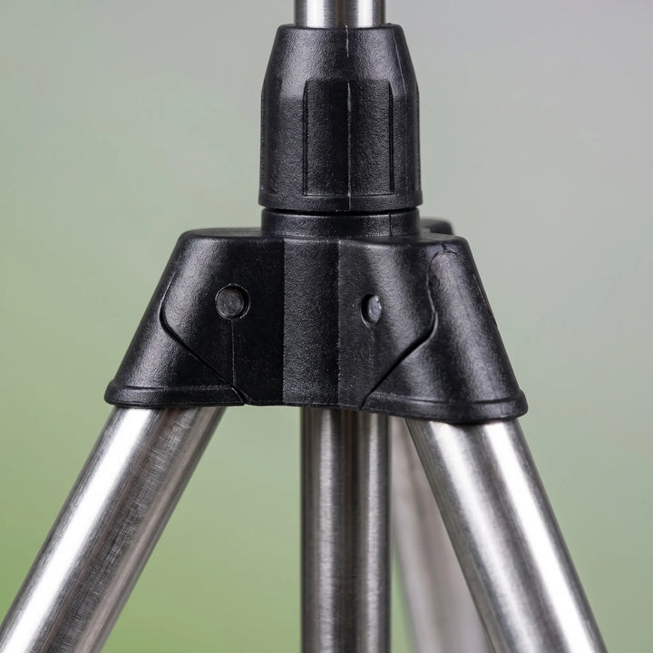 Adjustable tripod lawn sprinkler actively watering a green lawn, ideal for efficient garden irrigation & cooling.
