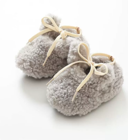 Plush non-slip baby animal booties, designed for infant comfort and secure early walking.