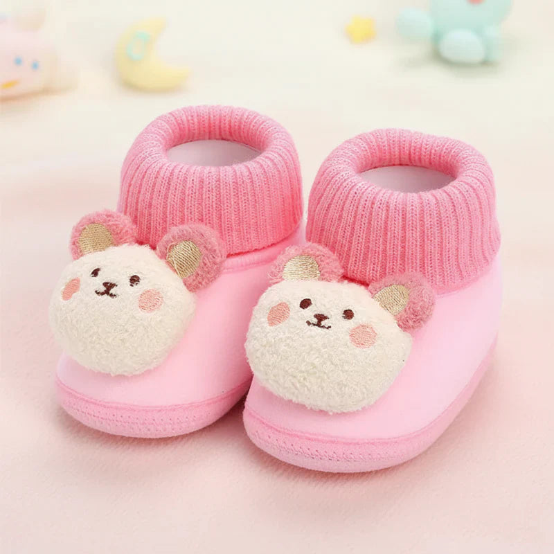 Warm baby animal slippers with a soft, non-slip sole, perfect for cold weather.
