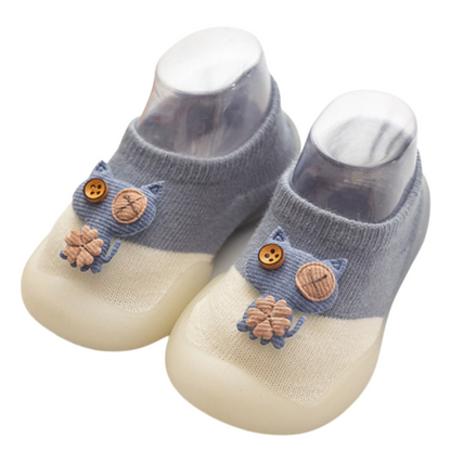 Toddler first steps anti-slip shoes, black and white cat design, soft and flexible for baby footwear.