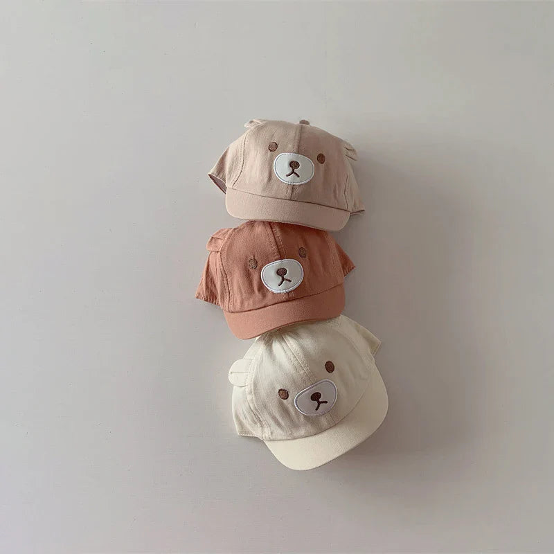 High-quality cotton blend baby cap with bear ears, designed for comfort and sun protection.