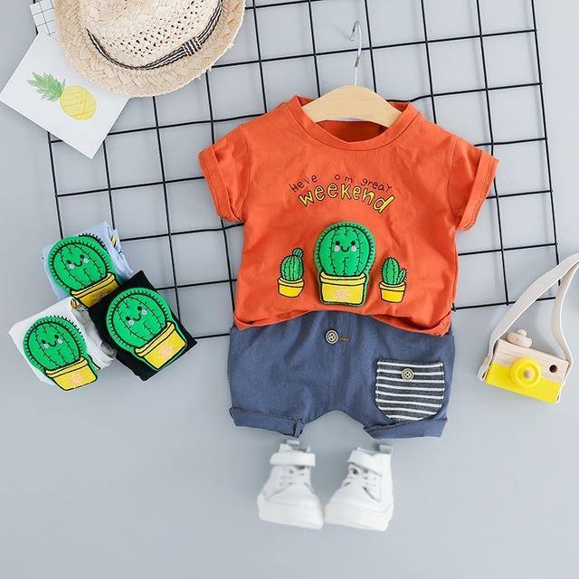 Toddler in a comfortable white cactus print playsuit, soft cotton blend baby summer clothes.