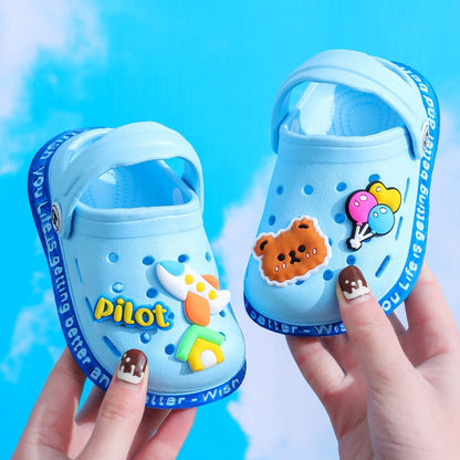 Toddler's feet in cartoon anti-slip comfort slippers, demonstrating flexibility and grip