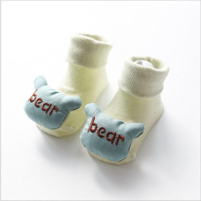 Toddler walking in non-slip cartoon doll cotton socks, providing a secure grip