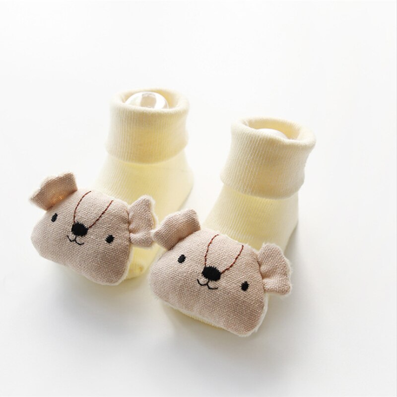 Soft, breathable cotton baby socks with a smiling cartoon doll and durable non-slip grips