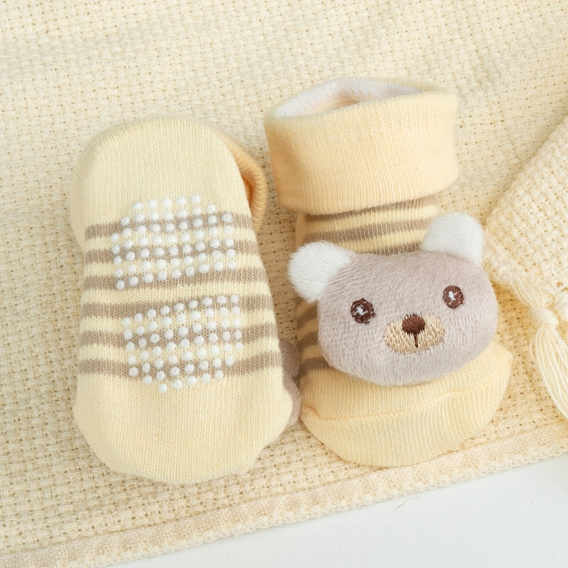 Soft cotton baby socks with cute cartoon doll design and non-slip grips for toddlers